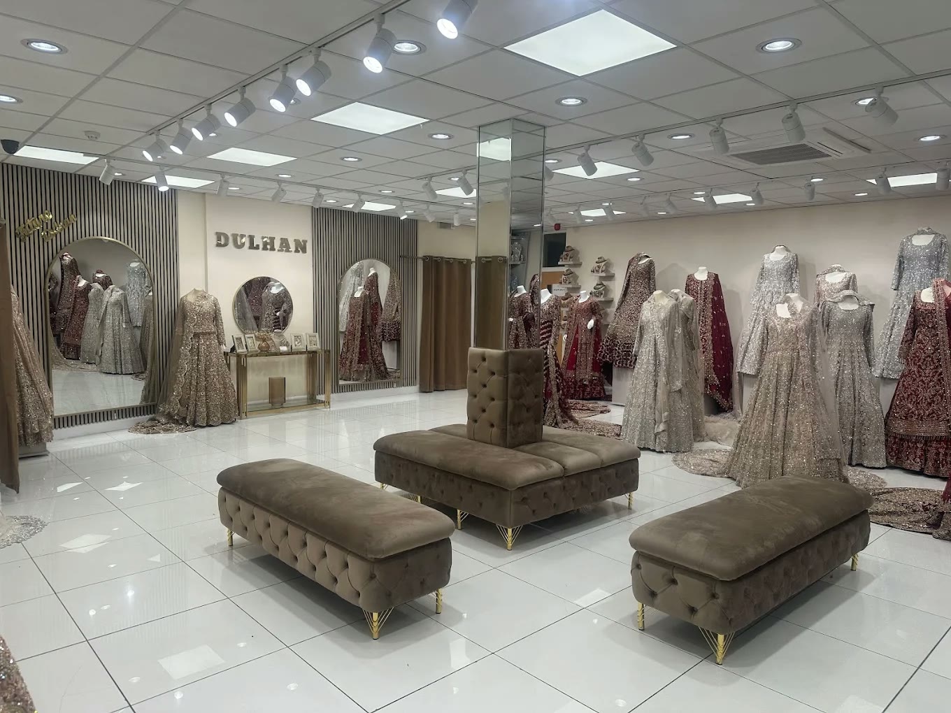The Dulhan Boutique interior on White Abbey Road, with bridal outfits arranged around the consultation seating area