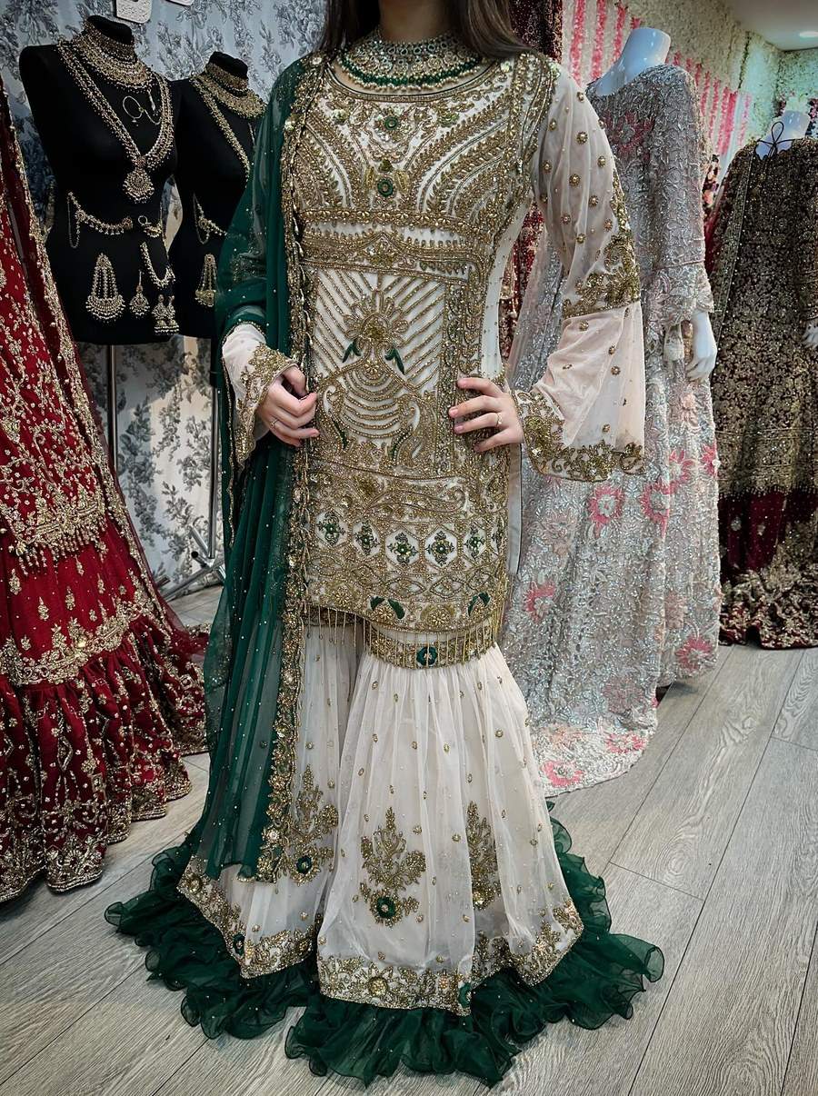 An ivory and gold bridal direction with an emerald trim to explore for a Mehndi celebration